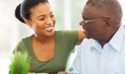 caregiver and senior man smiling