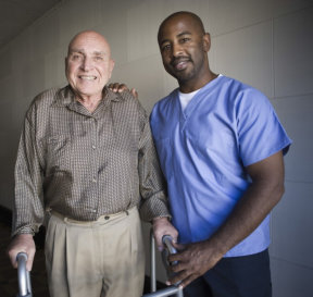 senior man and caregiver smiling