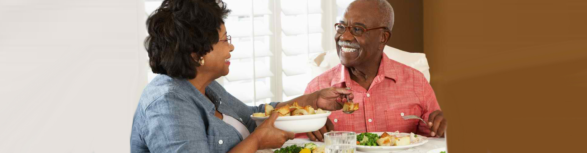 senior woman and man eating dinner